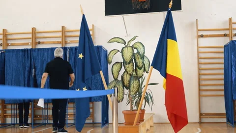 Voting area with flags and blue curtains inside polling station. Stock Footage 320961431