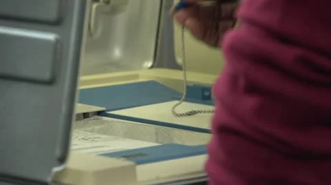 Voting, close up of hands punching ballot Stock Footage 12210009