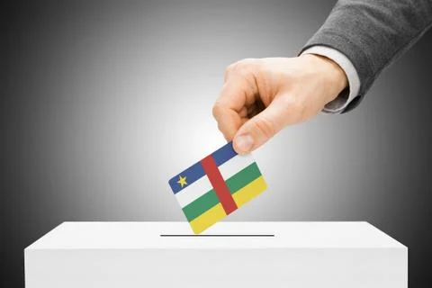 Voting concept - male inserting flag into ballot box - central african republ 写真素材