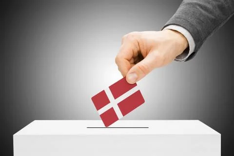 Voting concept - male inserting flag into ballot box - denmark Fotos de archivo