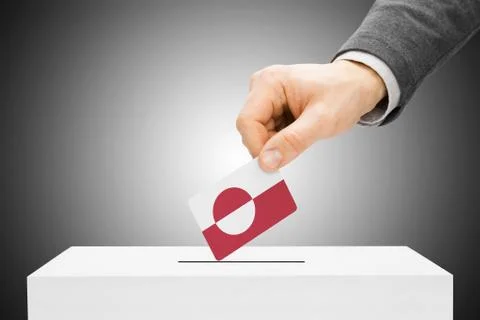 Voting concept - male inserting flag into ballot box - greenland Stock Photos