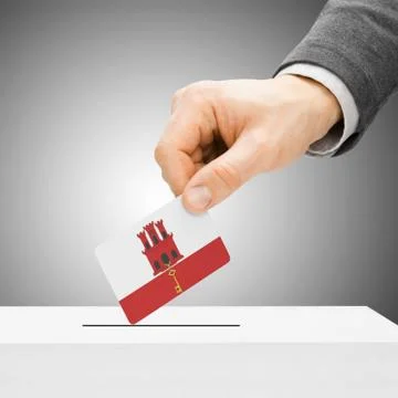 Voting concept - Male inserting flag into ballot box - Gibraltar 写真素材
