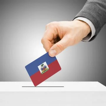 Voting concept - Male inserting flag into ballot box - Haiti 写真素材