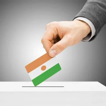 Voting concept - Male inserting flag into ballot box - Niger 写真素材