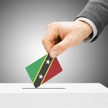 Voting concept - Male inserting flag into ballot box - Saint Kitts and Nevis Fotos de archivo