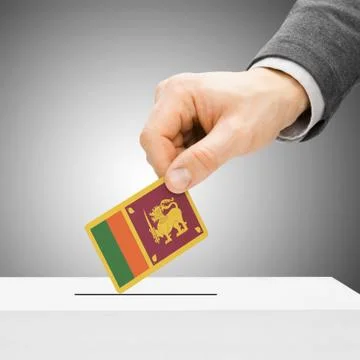 Voting concept - Male inserting flag into ballot box - Sri Lanka Foto stock