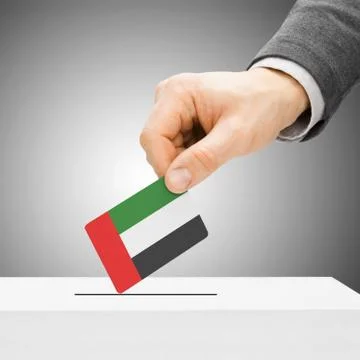Voting concept - Male inserting flag into ballot box - United Arab Emirates Stock Photos