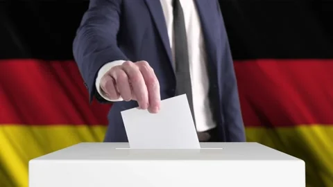 Voting. Man Putting a Ballot into a Voting Box with German Flag on Background. Stock Footage 173603451