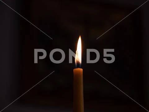 Votive candles alight in Church Stock Photos