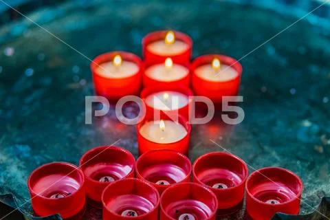 Votive candles forming the Cross Stock Photos