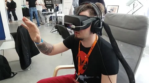 VR conference visitor tests virtual reality helmet Stock Footage