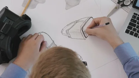 Vr developer drawing sketches for new prototype top view Stock Footage 94784453