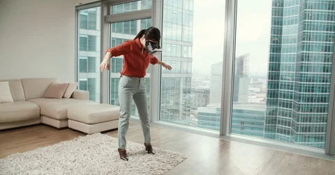 Vr first reaction of a young Asian girl with glasses virtual reality in modern Stock Footage