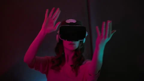 VR Futuristic Woman Using Virtual Reality Headset Looking Around At Interactive Stock Footage 154455403