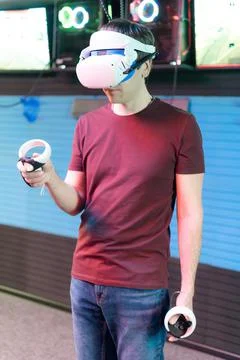 Vr game and virtual reality. man gamer fun playing on futuristic simulation v Stock Photos