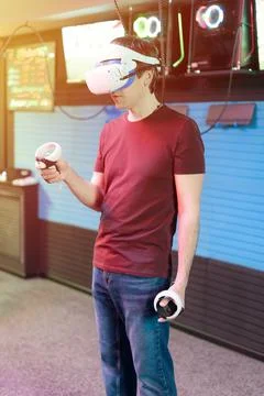 Vr game and virtual reality. man gamer fun playing on futuristic simulation v Stock Photos
