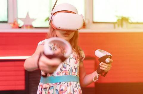 Vr game and virtual reality. kid girl gamer eight years old fun playing on fu Stock Photos