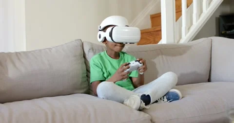 VR game is starting, causing child to manipulate white controller while wearing Stock Footage 341943894