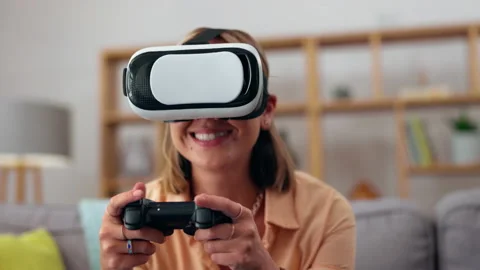 VR, gaming console and woman on sofa Stock Video Pond5
