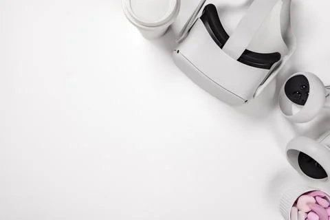 VR glasses with controller by marshmallows on desk Stock Photos