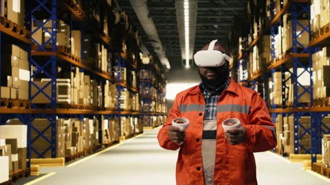 VR glasses demonstration, in warehouse facility, with black personnel working Stock Footage 332907531