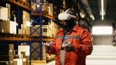 VR glasses demonstration, in warehouse facility, with black personnel working Stock Footage 332909765