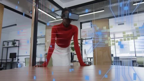 VR headset activating, woman tech professional leaning at table navigating code Stock Footage 334371961