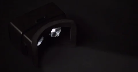 VR headset with glowing eye pieces in the dark Stock Footage 121183806