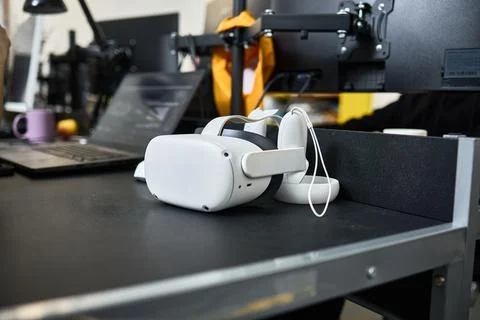 VR headset resting on a contemporary workspace table highlights cutting-edge  Stock Photos