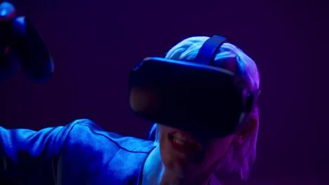 VR headset youngster playing augmented reality simulation. Man using controllers Stock Photos