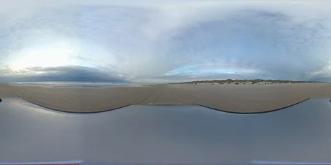 VR360, Car drives over sandy beach on the North Sea, VR Stock Footage 117537152