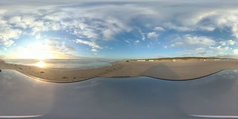 VR360, Car drives over sandy beach by sunset, North Sea, VR Stock Footage 117538396