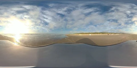 VR360, Car drives over sandy beach by sunset, North Sea, VR Stock Footage 117538821