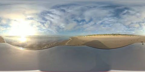 VR360, Car drives over sandy beach by sunset, North Sea, VR Stock Footage 117538905