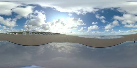 VR360, Car drives over sandy beach with bath houses, North Sea, VR Stock Footage 117539288