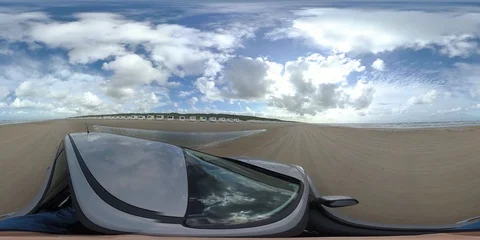 VR360, Car drives over sandy beach with bath houses, North Sea, VR Stock Footage 117709211