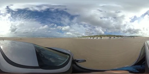 VR360, Car drives over sandy beach with bath houses, North Sea, VR Stock Footage 117709423