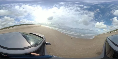 VR360, Car drives over sandy beach with bath houses, North Sea, VR Stock Footage 117709529