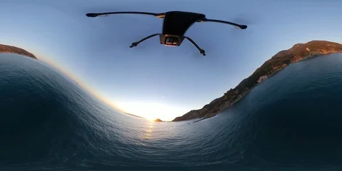 VR360 A Drone flying over the sea at sunset crashes on a cliff Video stock 106315446