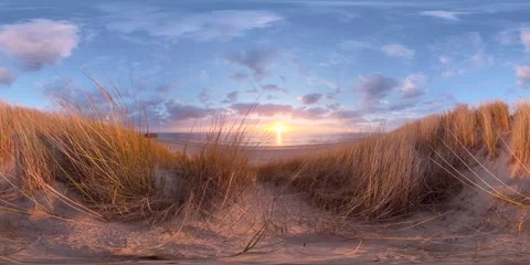 VR360, A dune covered in dune grass by the sea at sunset Stockbeeldmateriaal 334625884