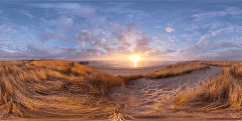 VR360, A dune covered in dune grass by the sea at sunset Stockbeeldmateriaal 334626022
