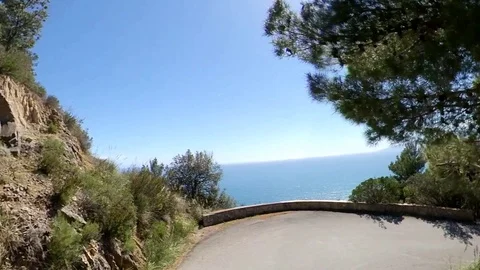 VR360 effect a car runs along a panoramic road on the sea in a sunny evening Stock Footage 107192332
