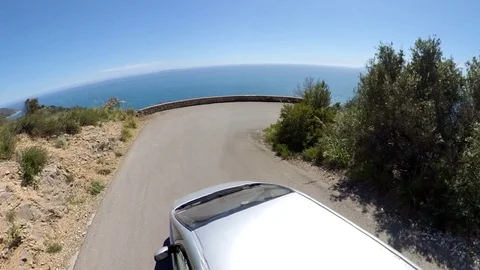 VR360 effect a car runs along a panoramic road on the sea in a sunny evening Stock Footage 107192487
