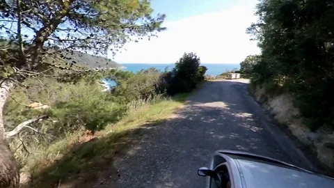 VR360 effect a car runs along a panoramic road on the sea in a sunny evening Stock Footage 107192572