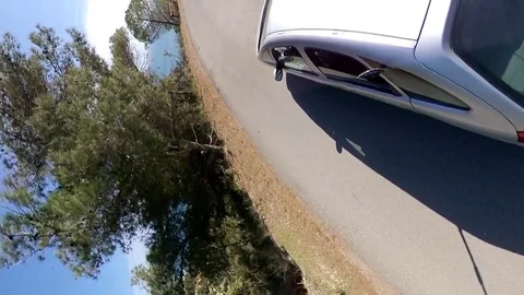 VR360 effect a car runs along a panoramic road on the sea in a sunny evening Stock Footage 107444636