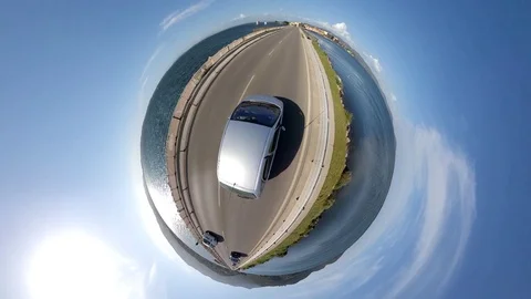 VR360 Effect  - A car runs in the evening on a bridge on a lagoon Stock Footage 107325521