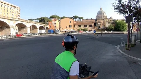 VR360 effect A cyclist rides in Rome near st Peter Dome Stock Footage 107180272