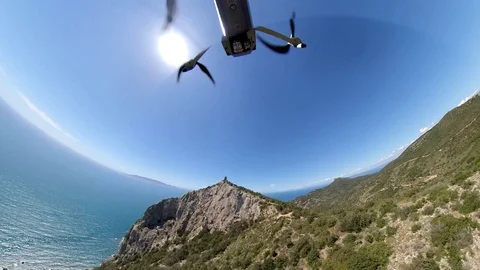 VR360 effect  a drone flies over an high cliff with a tower at distance Stock Footage 107192536
