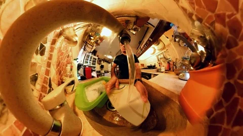 VR360 effect,  A man in a Kitchen washes the dishes, close up view from the sink Stock Footage 103161970