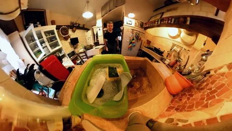 VR360 effect,  A man in a Kitchen washes the dishes, close up view from the sink Stock Footage 103161973